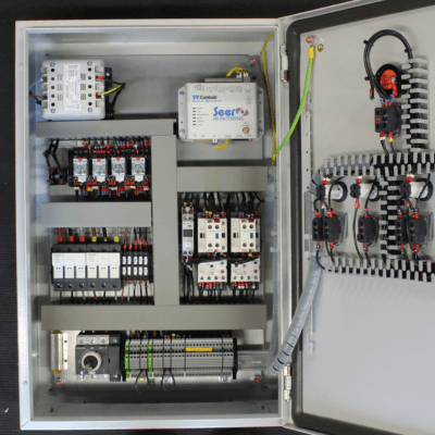 A T-T Control unit with it's door open, showing wires, electronics and a T-T Seer Micro installed inside.